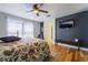 Cozy bedroom with hardwood floors, natural light and a TV at 632 Monument Point St, Henderson, NV 89002