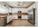 Well-equipped kitchen with stainless steel appliances, white cabinets, and tile flooring at 632 Monument Point St, Henderson, NV 89002