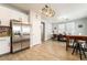 Bright kitchen area features a stainless steel refrigerator and eat-in dining area with stylish light fixture at 632 Monument Point St, Henderson, NV 89002
