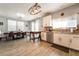The kitchen features stainless steel appliances, white cabinets and a view of the dining area at 632 Monument Point St, Henderson, NV 89002