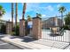 Community pool with outdoor seating, palm trees, and clear water visible behind decorative fence at 632 Monument Point St, Henderson, NV 89002