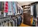 Organized walk-in closet with clothes neatly hanging on rods and folded on shelves at 632 Monument Point St, Henderson, NV 89002