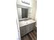 Bathroom vanity featuring modern fixtures and hardware, wood-look flooring, and gray tones at 708 Fernwood Ln, Las Vegas, NV 89169