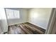 A small bedroom featuring laminate floors, white trim, and one window at 708 Fernwood Ln, Las Vegas, NV 89169