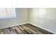 A well lit bedroom featuring laminate floors, white trim, and one window at 708 Fernwood Ln, Las Vegas, NV 89169