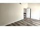 Neutral bedroom featuring wood-look floors, white walls, and two entryways at 708 Fernwood Ln, Las Vegas, NV 89169