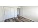 A spacious bedroom with laminate floors, white trim and a large sliding door closet at 708 Fernwood Ln, Las Vegas, NV 89169