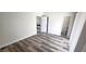 Neutral bedroom featuring wood-look floors, white walls, and two entryways at 708 Fernwood Ln, Las Vegas, NV 89169
