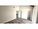 Neutral bedroom featuring wood-look floors, white walls, and two entryways at 708 Fernwood Ln, Las Vegas, NV 89169