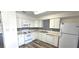 Well-lit kitchen featuring white appliances, ample counter space, and a decorative backsplash at 708 Fernwood Ln, Las Vegas, NV 89169