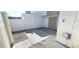 A secure, private patio area with a concrete pad, rock landscape, and gated entryway at 708 Fernwood Ln, Las Vegas, NV 89169