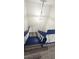 An ornate chandelier hangs above blue painted stairs with laminate floors at 708 Fernwood Ln, Las Vegas, NV 89169