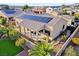A backyard with a covered patio, manicured lawn, professional landscape, solar panels, and privacy wall at 7331 Abundant Harvest Ave, Las Vegas, NV 89131