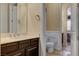 Bright bathroom showcasing a marble-topped vanity, a large mirror, and a connecting toilet room at 7331 Abundant Harvest Ave, Las Vegas, NV 89131