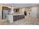 Stylish kitchen featuring dark cabinets, stainless steel appliances, and a breakfast bar for easy mornings at 7331 Abundant Harvest Ave, Las Vegas, NV 89131