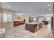 Bright, open floor plan showcasing the living room, kitchen with island, and dining area, perfect for entertaining at 7331 Abundant Harvest Ave, Las Vegas, NV 89131