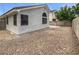 View of backyard featuring rocks, fencing, and an exterior view of the home at 7524 Fencerow St, Las Vegas, NV 89131