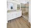 Bathroom featuring new vanity, laminate flooring, and a tiled shower with a bench at 7524 Fencerow St, Las Vegas, NV 89131