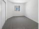Bright bedroom featuring neutral carpet, white walls, a window, and closet space at 7524 Fencerow St, Las Vegas, NV 89131
