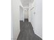 Hallway featuring neutral-toned walls and plush carpet, leading to various rooms at 7524 Fencerow St, Las Vegas, NV 89131