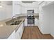 Well-lit kitchen featuring stainless steel appliances, granite countertops, and white cabinetry at 7524 Fencerow St, Las Vegas, NV 89131