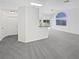 Open-concept living room featuring plush carpet, white walls, and natural light at 7524 Fencerow St, Las Vegas, NV 89131