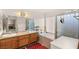 Bathroom featuring a double vanity, bathtub, and shower at 7544 Shangri La Ave, Las Vegas, NV 89147
