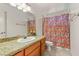 Bathroom with granite vanity and patterned shower curtain at 7544 Shangri La Ave, Las Vegas, NV 89147