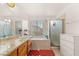 Bright bathroom featuring double sink, granite countertops, and a separate tub and shower at 7544 Shangri La Ave, Las Vegas, NV 89147