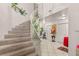 Grand entryway featuring a curved staircase and modern tile flooring at 7544 Shangri La Ave, Las Vegas, NV 89147