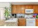 Well-lit kitchen with granite countertops and modern white appliances at 7544 Shangri La Ave, Las Vegas, NV 89147