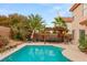 Backyard pool with a pergola covered outdoor dining set at 7544 Shangri La Ave, Las Vegas, NV 89147