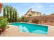 Backyard pool surrounded by lush landscaping, trees, and a privacy wall at 7544 Shangri La Ave, Las Vegas, NV 89147