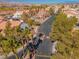 Aerial view of a gated community featuring lush landscaping, mature palm trees, and a sparkling pool area at 7570 W Flamingo Rd # 202, Las Vegas, NV 89147
