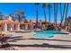 Community pool with waterfall feature, sundeck, and shaded seating area for residents to enjoy at 7570 W Flamingo Rd # 202, Las Vegas, NV 89147