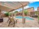 Inviting backyard oasis features a pool, jacuzzi, and covered patio area at 765 Crimson Peak Pl, Henderson, NV 89011