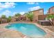 Gorgeous backyard features a pool, a jacuzzi, and landscaped desert surroundings at 765 Crimson Peak Pl, Henderson, NV 89011