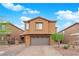 Charming two-story home with a well-maintained lawn, paved driveway, and a spacious two-car garage at 765 Crimson Peak Pl, Henderson, NV 89011