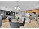 Open living space featuring a modern kitchen, cozy living room, and a stylish dining area at 765 Crimson Peak Pl, Henderson, NV 89011
