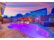 Stunning backyard features in-ground pool, spa, covered patio, and modern fencing at 765 Crimson Peak Pl, Henderson, NV 89011