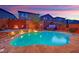 Inviting backyard pool and spa with a fire pit and elegant stone surroundings at 765 Crimson Peak Pl, Henderson, NV 89011