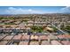 Aerial view of a house in a suburban neighborhood with a view of the surrounding landscape at 7694 Hampton Park Ln, Las Vegas, NV 89113