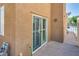 Private back patio area with tile flooring and sliding glass door access at 7694 Hampton Park Ln, Las Vegas, NV 89113