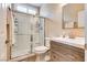 Bathroom featuring sliding glass shower doors, single sink vanity, and updated fixtures at 7694 Hampton Park Ln, Las Vegas, NV 89113