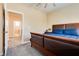 Bedroom with stylish bed, neutral walls, and doorway to bath and laundry at 7694 Hampton Park Ln, Las Vegas, NV 89113