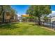 Green grass area in a community park with mature landscaping and shade trees at 7694 Hampton Park Ln, Las Vegas, NV 89113