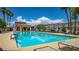 Sparkling community pool with plenty of seating and lounge areas at 7694 Hampton Park Ln, Las Vegas, NV 89113