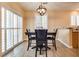 Comfortable dining room with dark wood table and chairs with view of sliding door and plantation shutters at 7694 Hampton Park Ln, Las Vegas, NV 89113