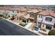 A view of a well-maintained two-story home with attractive landscaping and ample parking at 7694 Hampton Park Ln, Las Vegas, NV 89113