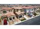 A view of a well-maintained two-story home with attractive landscaping and ample parking at 7694 Hampton Park Ln, Las Vegas, NV 89113